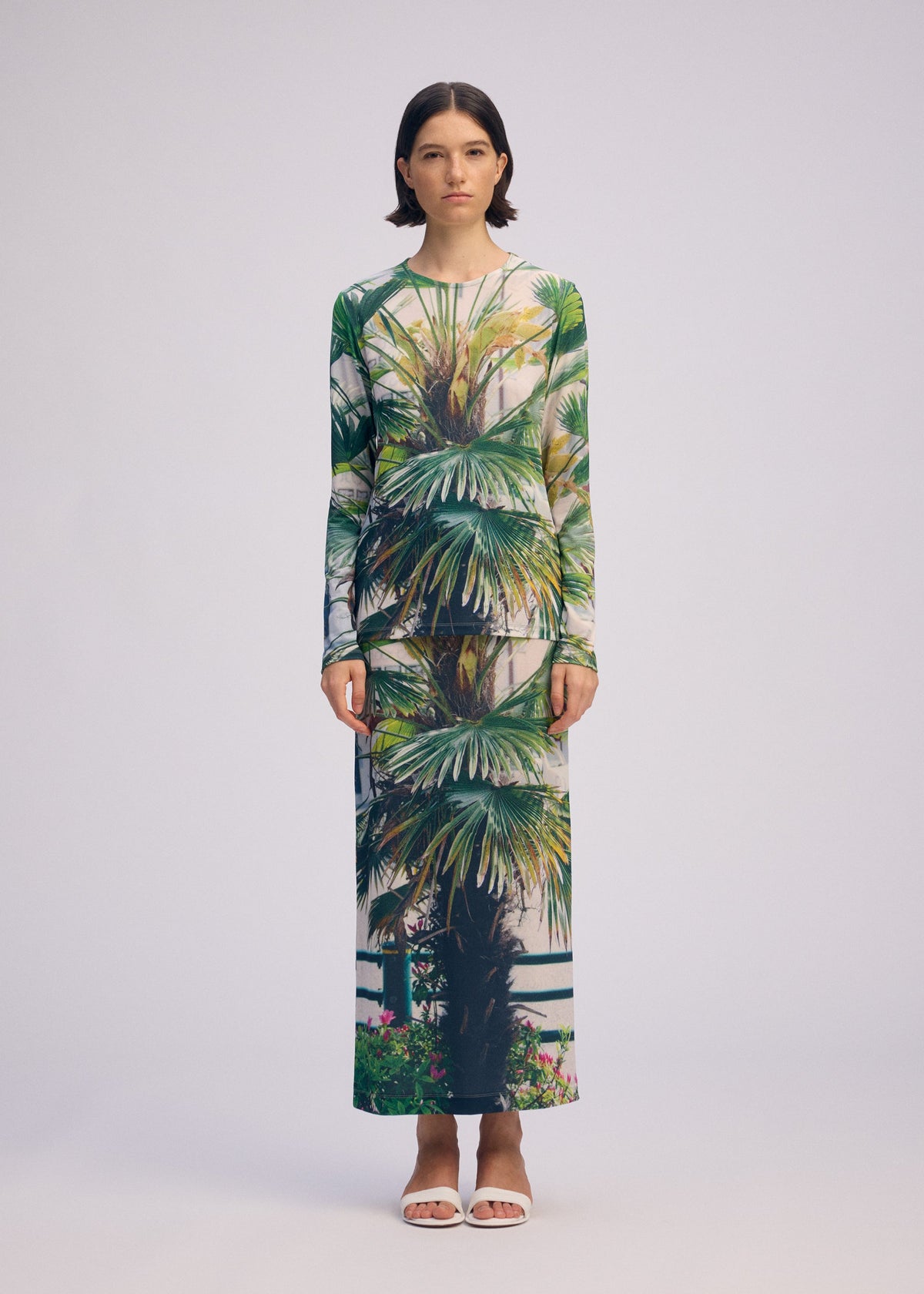 A model wears the ISSEY MIYAKE URBAN JUNGLE JERSEY skirt.