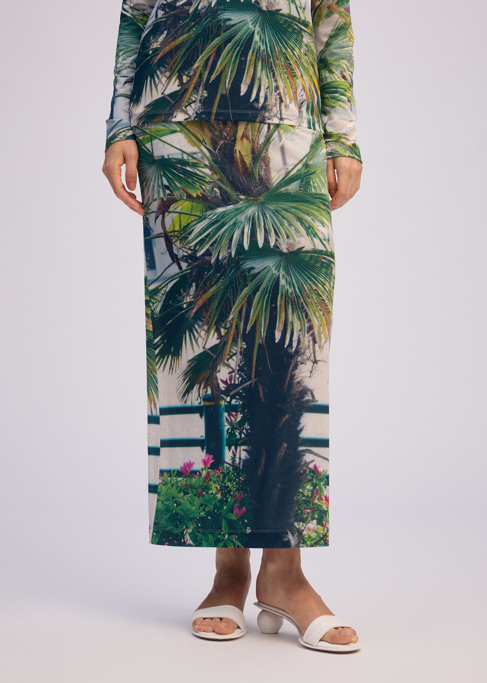 A model wears the ISSEY MIYAKE URBAN JUNGLE JERSEY skirt.