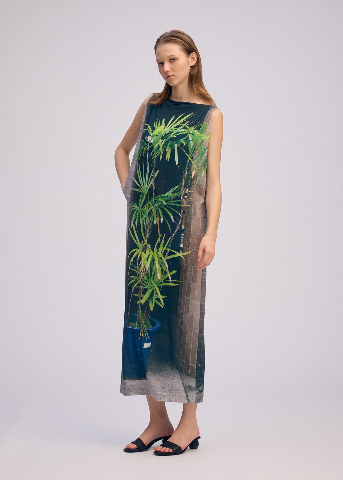 A model wears the ISSEY MIYAKE URBAN JUNGLE JERSEY dress.