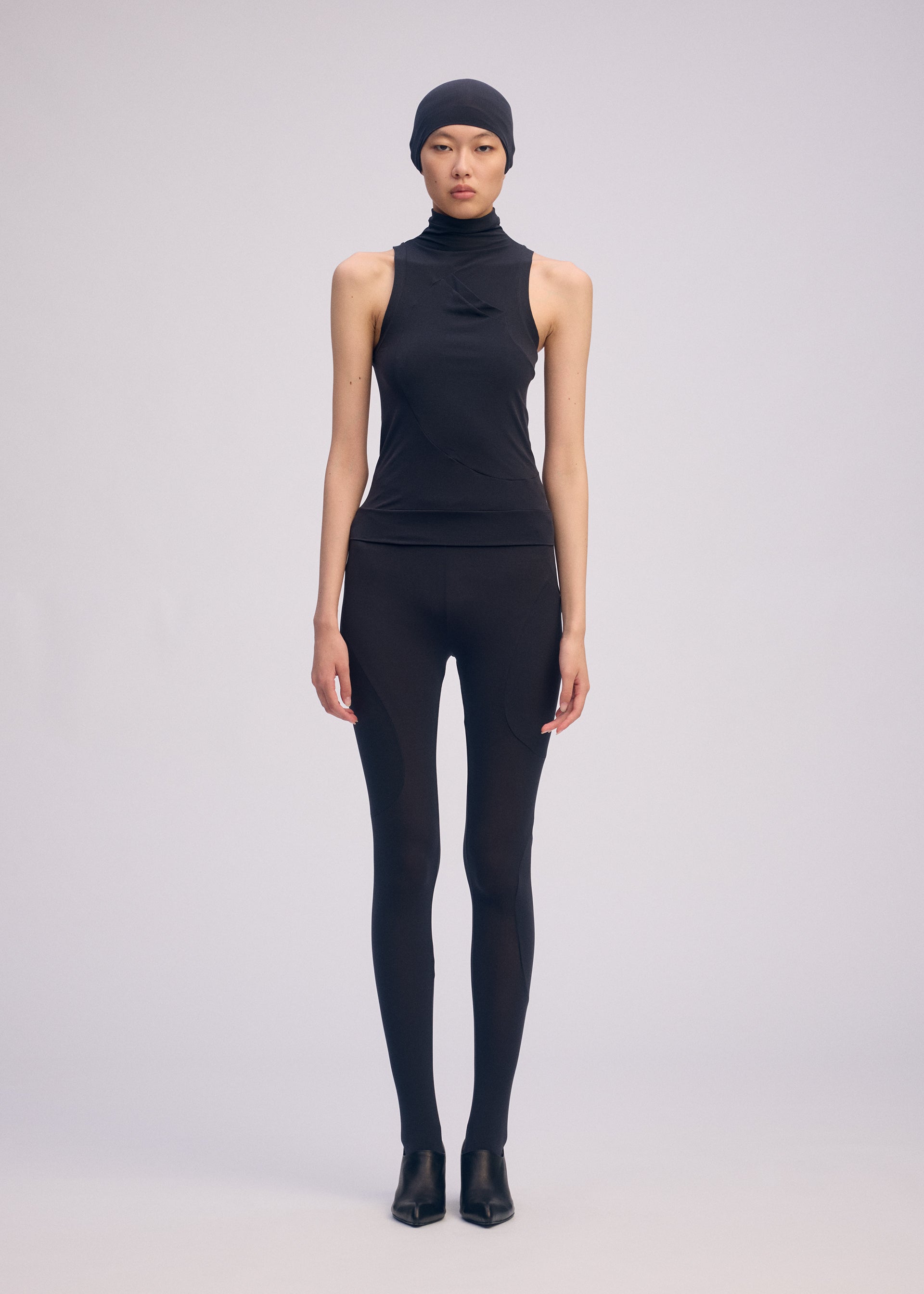A model wears the ISSEY MIYAKE A SHOPPER'S BODY clothing.