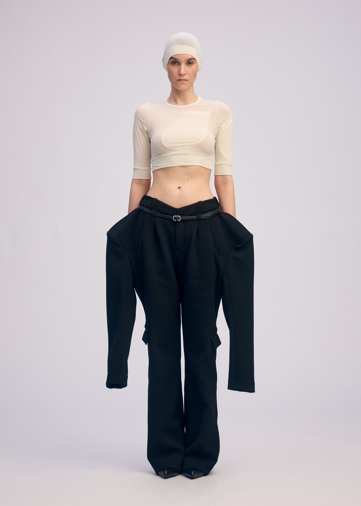 A model wears the ISSEY MIYAKE A SHOPPER'S BODY clothing.