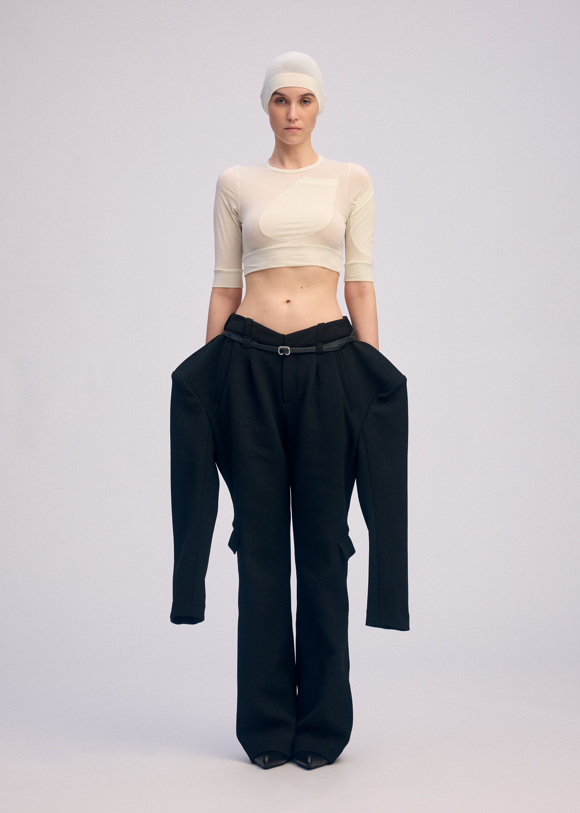 A model wears the ISSEY MIYAKE A SHOPPER'S BODY clothing.