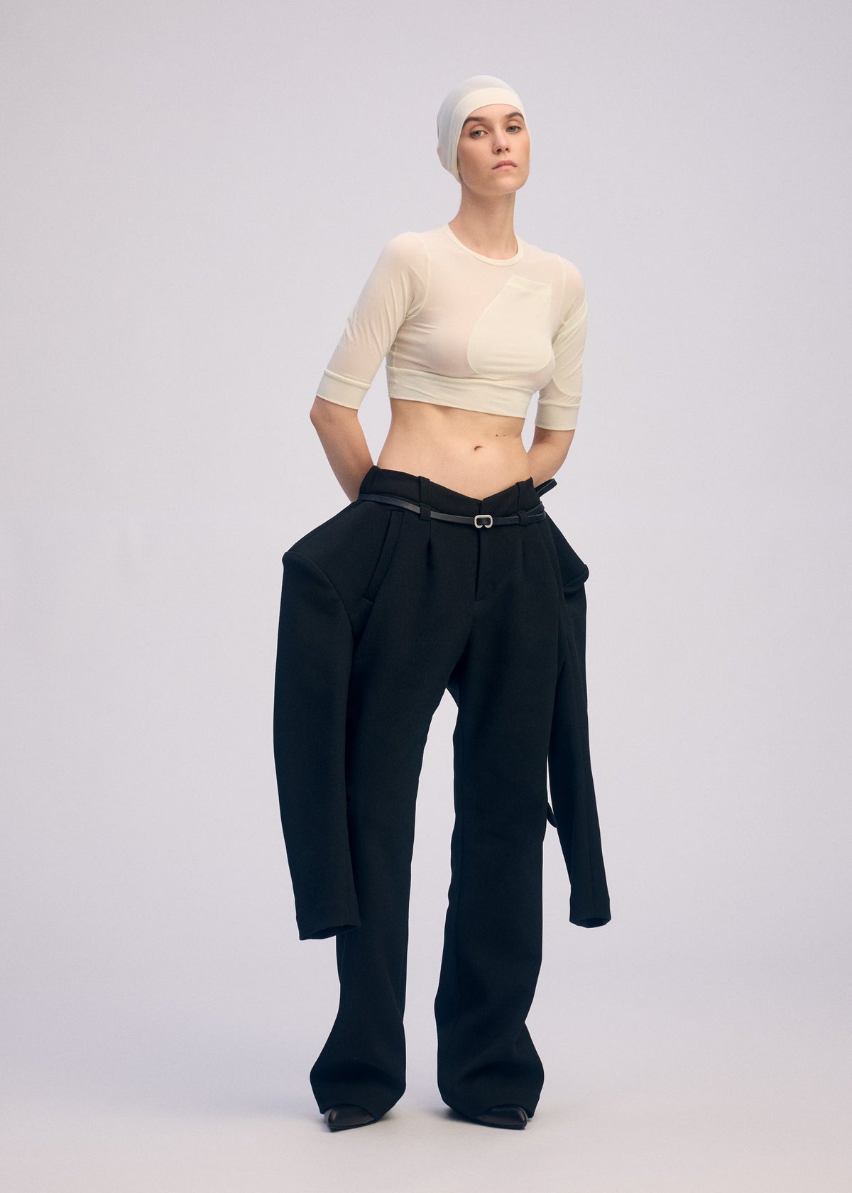 A model wears the ISSEY MIYAKE A SHOPPER'S BODY clothing.