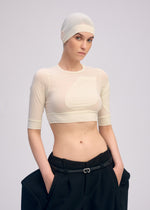 A model wears the ISSEY MIYAKE A SHOPPER'S BODY clothing.