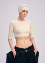A model wears the ISSEY MIYAKE A SHOPPER'S BODY clothing.