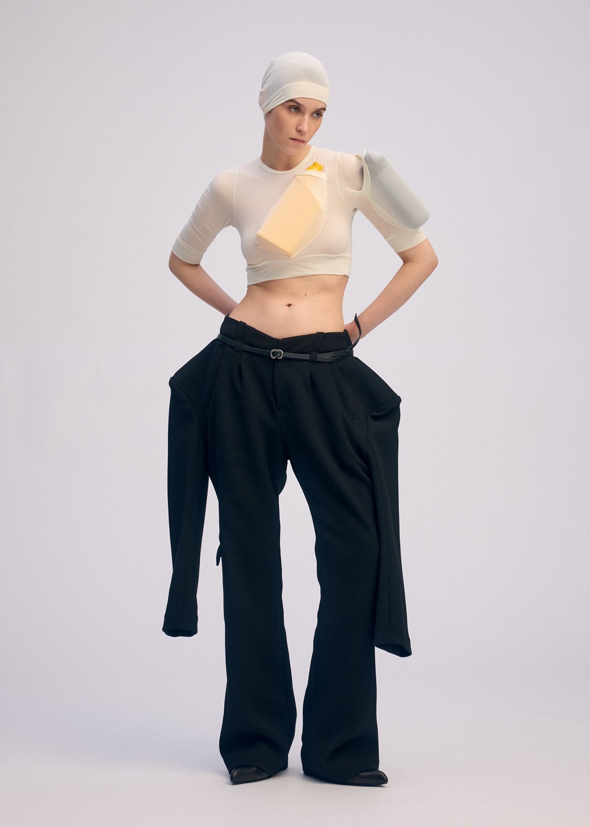 A model wears the ISSEY MIYAKE A SHOPPER'S BODY clothing.