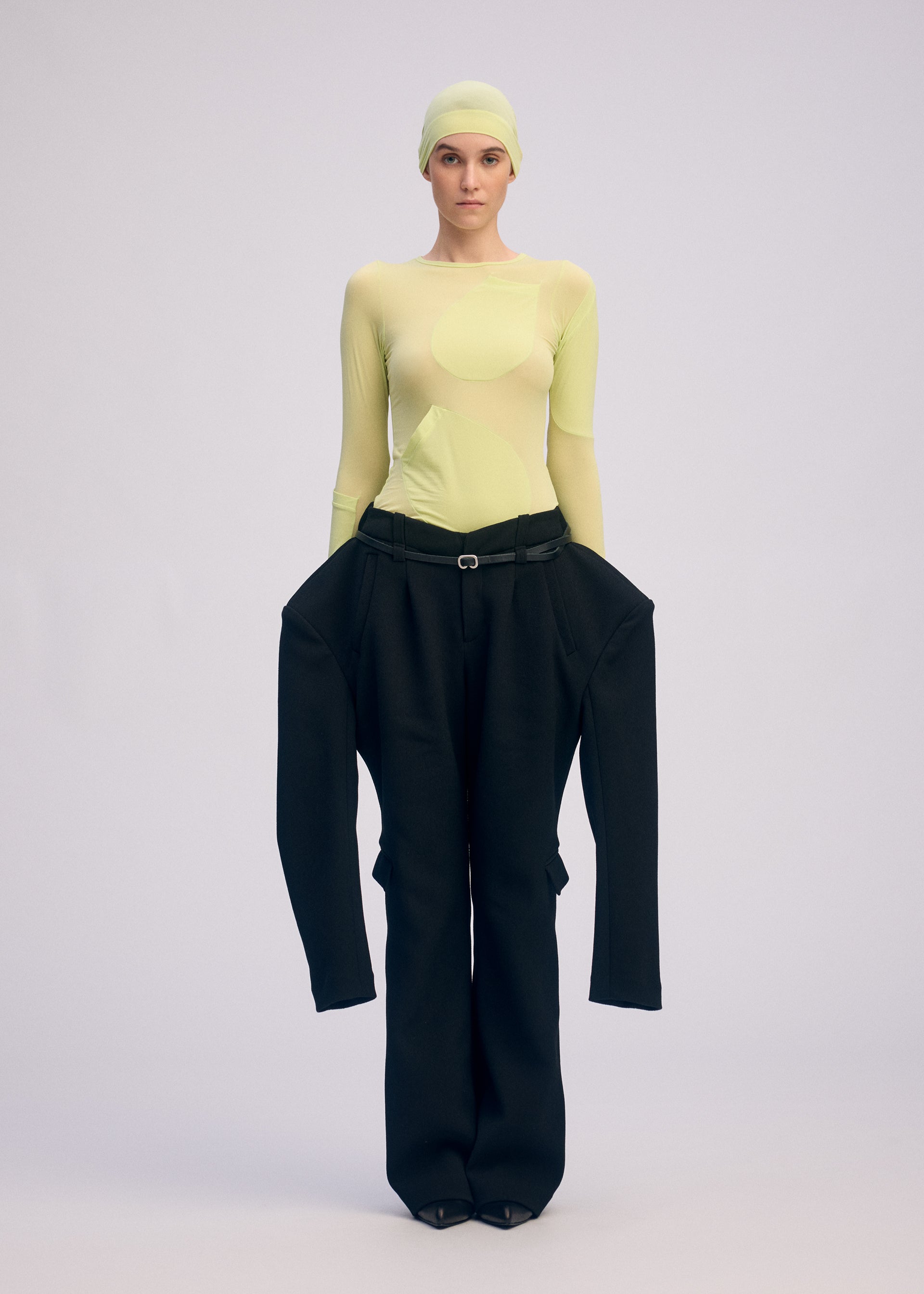 A model wears the ISSEY MIYAKE A SHOPPER'S BODY clothing.