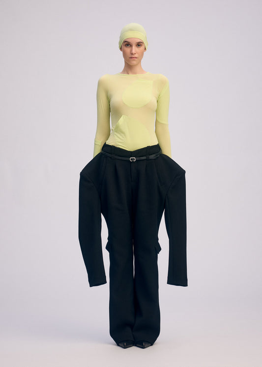 A model wears the ISSEY MIYAKE A SHOPPER'S BODY clothing.