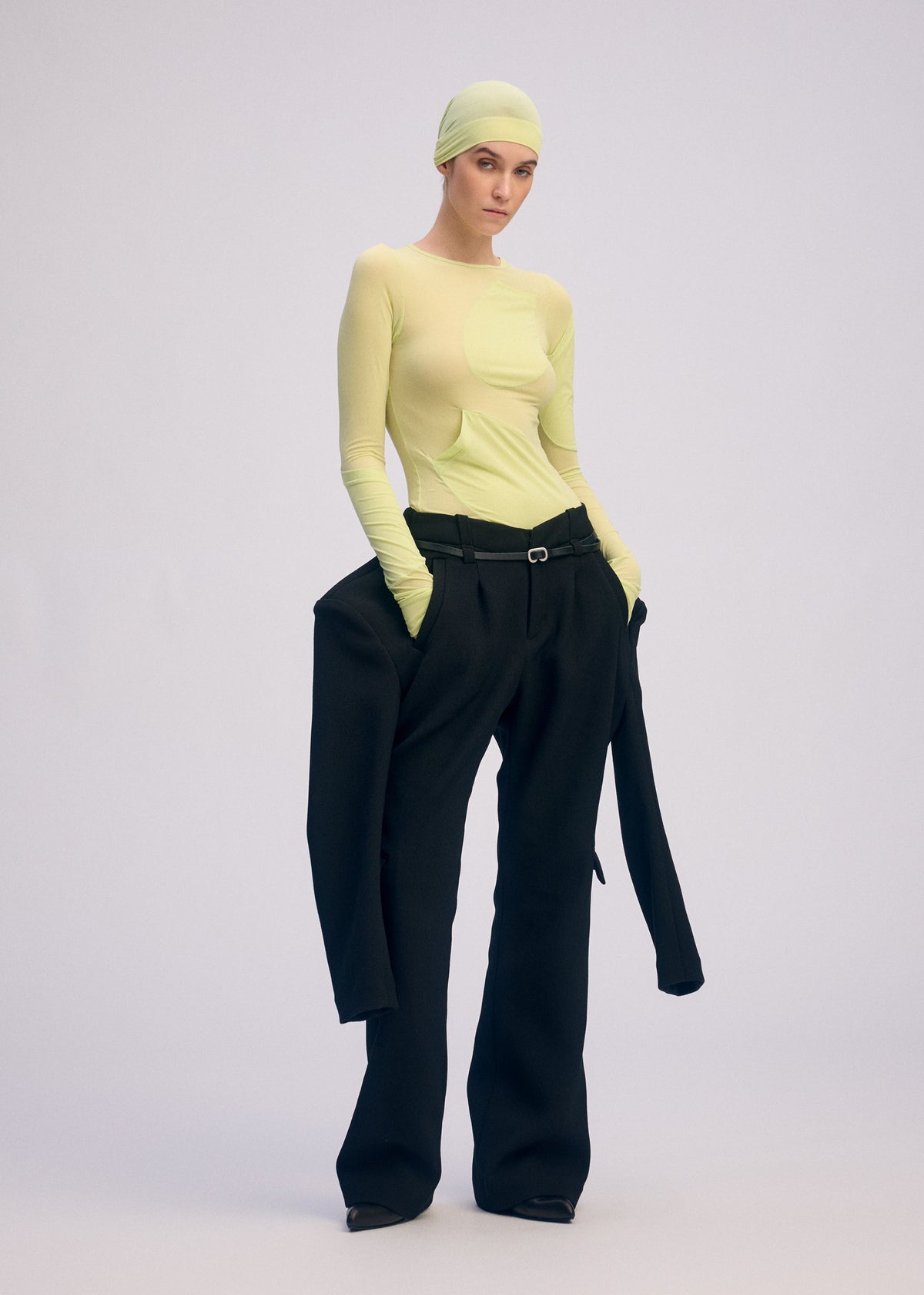 A model wears the ISSEY MIYAKE A SHOPPER'S BODY clothing.