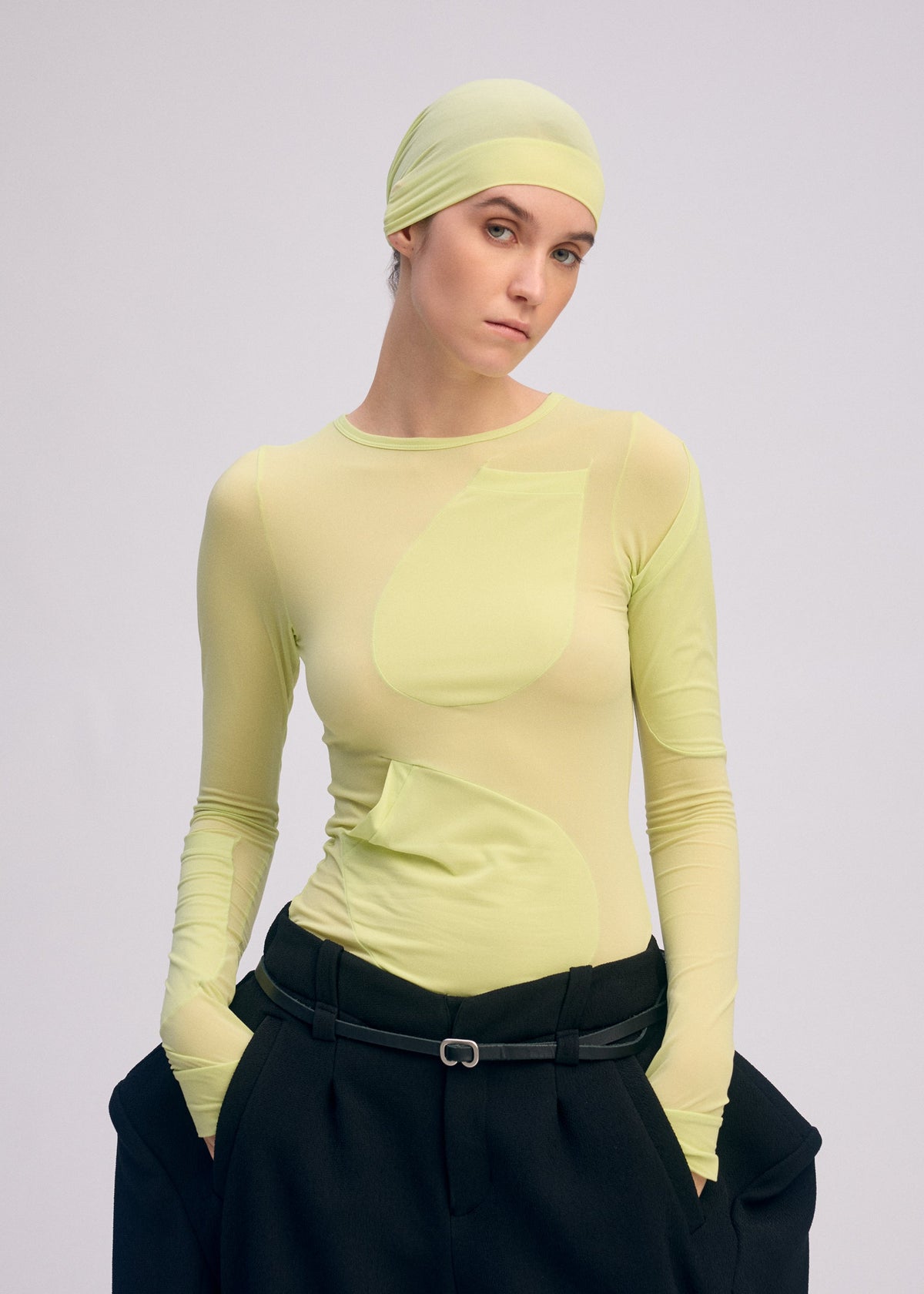 A model wears the ISSEY MIYAKE A SHOPPER'S BODY clothing.