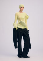 A model wears the ISSEY MIYAKE A SHOPPER'S BODY clothing.