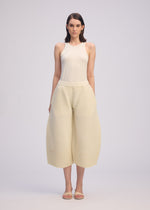 A model wears the ISSEY MIYAKE CORRUGATED KNIT trousers.