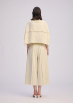 A model wears the ISSEY MIYAKE CAMPAGNE trousers.