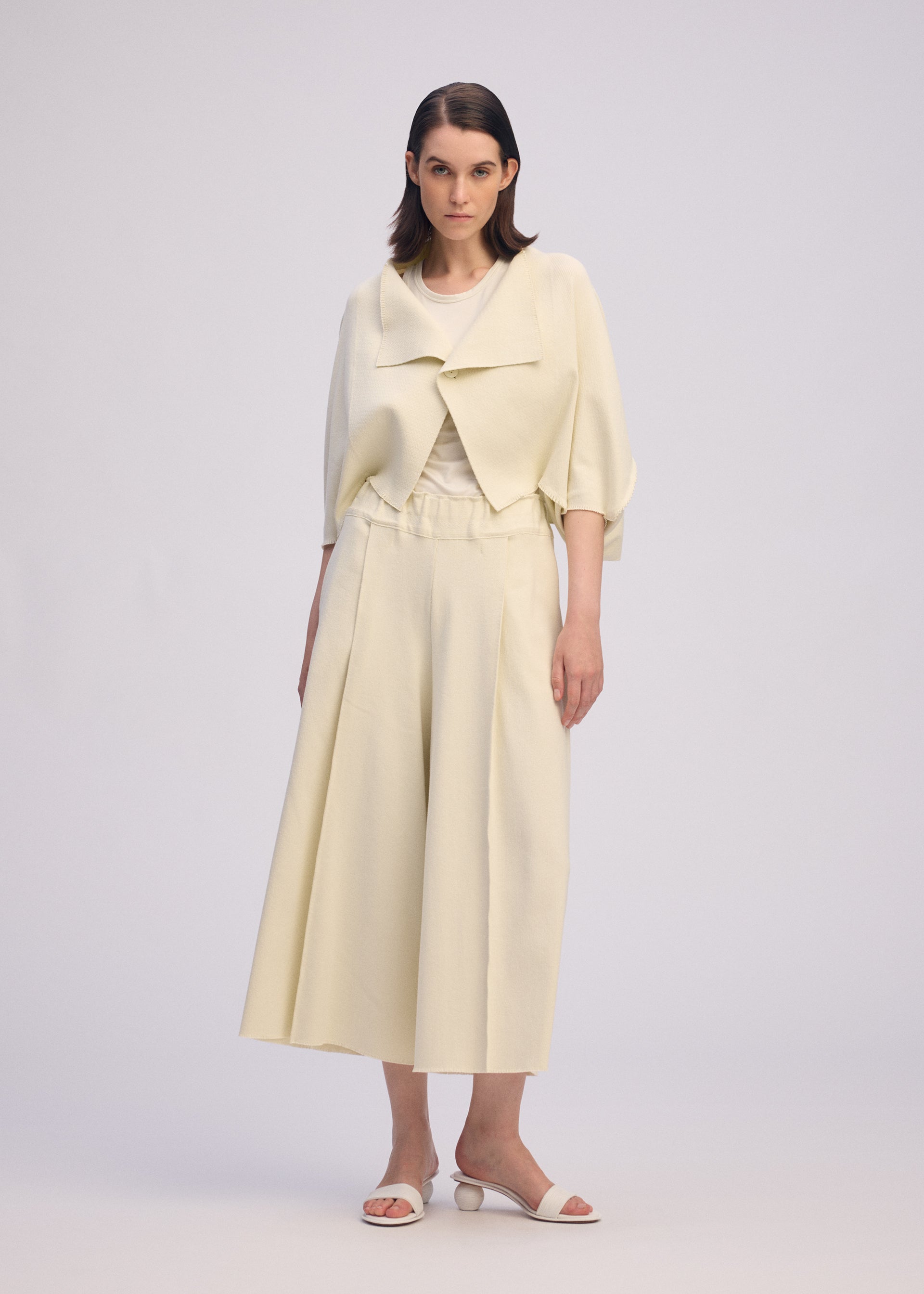 A model wears the ISSEY MIYAKE CAMPAGNE trousers.