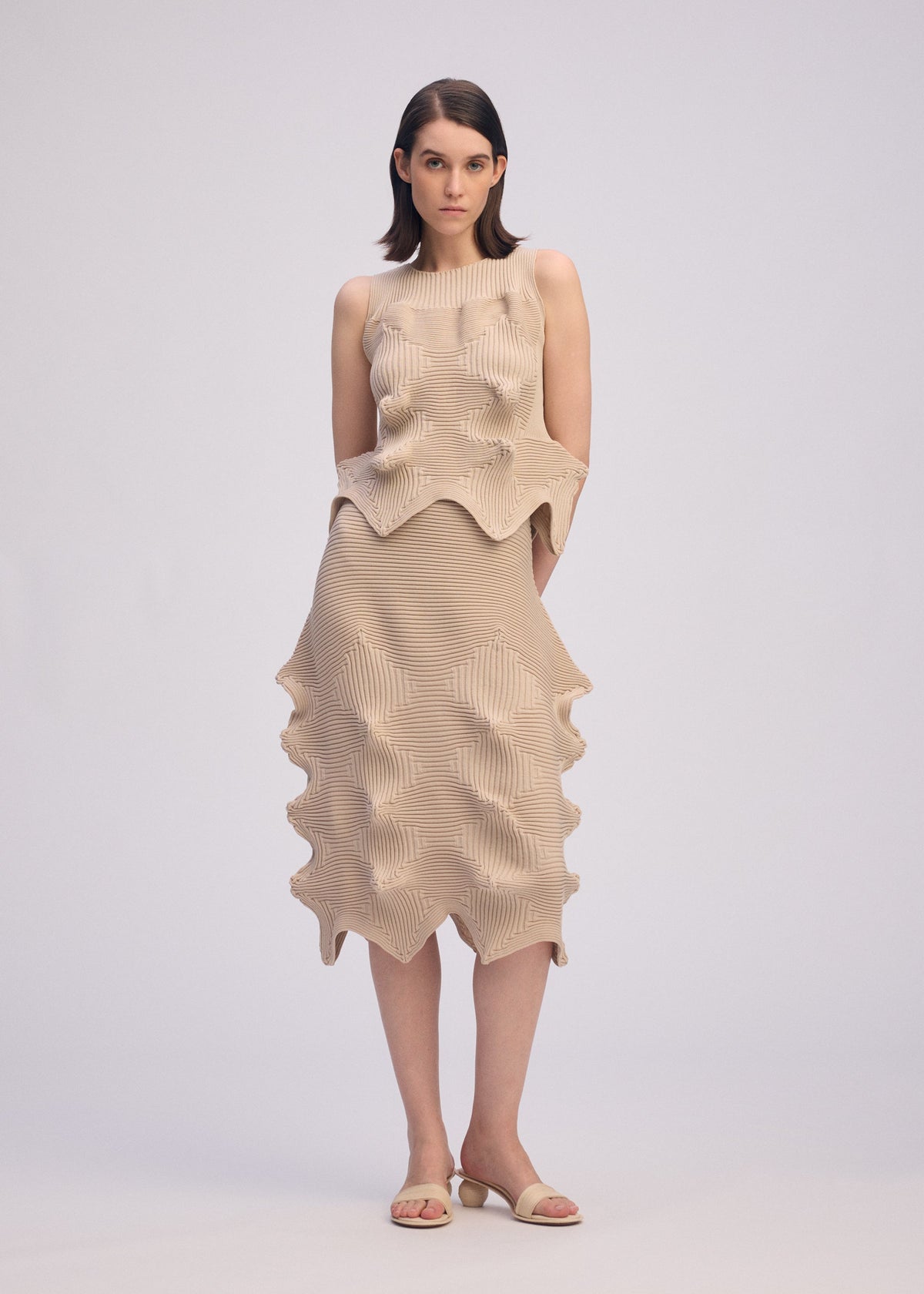 A model wears the ISSEY MIYAKE LINKAGE skirt.