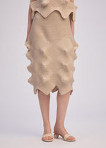 A model wears the ISSEY MIYAKE LINKAGE skirt.