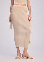 A model wears the ISSEY MIYAKE ADVENTITIOUS HIGH NECKS skirt.