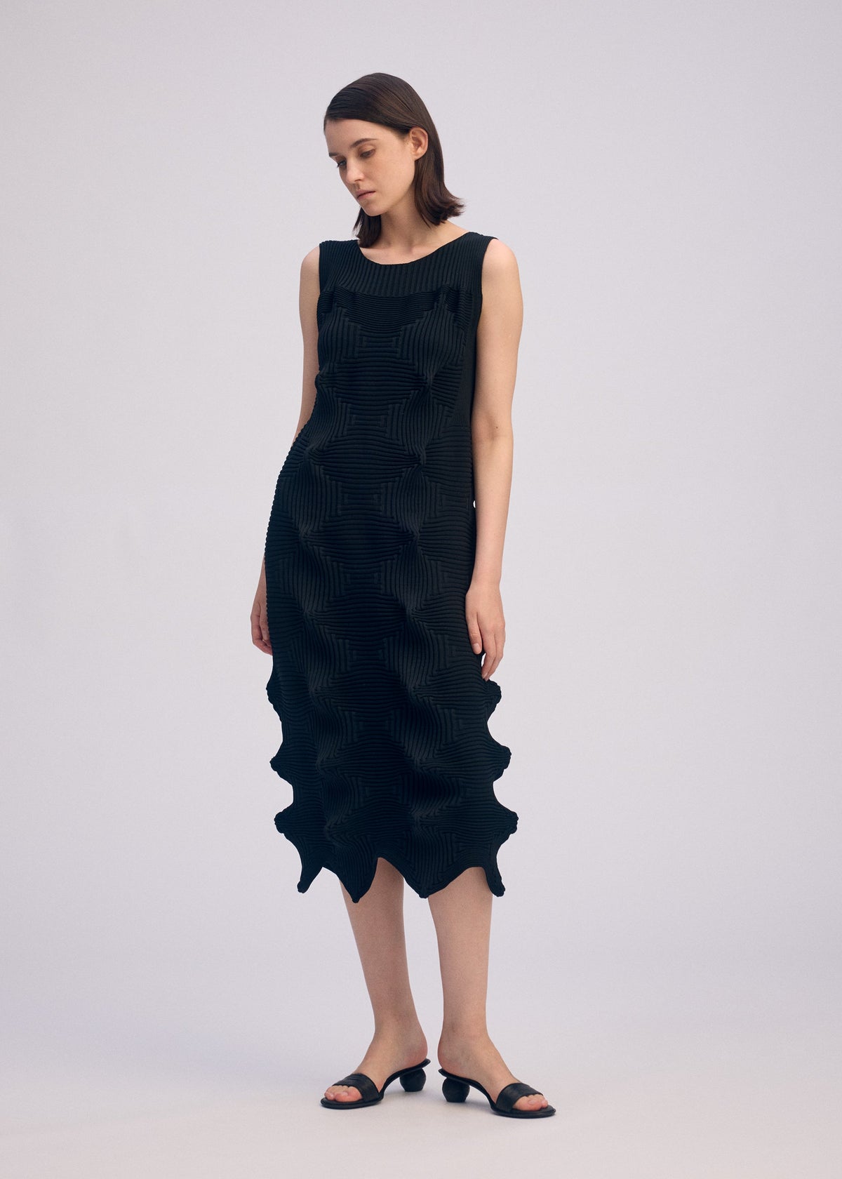 A model wears the ISSEY MIYAKE LINKAGE dress.