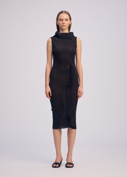 A model wears the ISSEY MIYAKE ADVENTITIOUS HIGH NECKS dress.