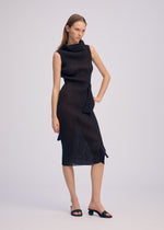 A model wears the ISSEY MIYAKE ADVENTITIOUS HIGH NECKS dress.