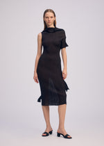 A model wears the ISSEY MIYAKE ADVENTITIOUS HIGH NECKS dress.