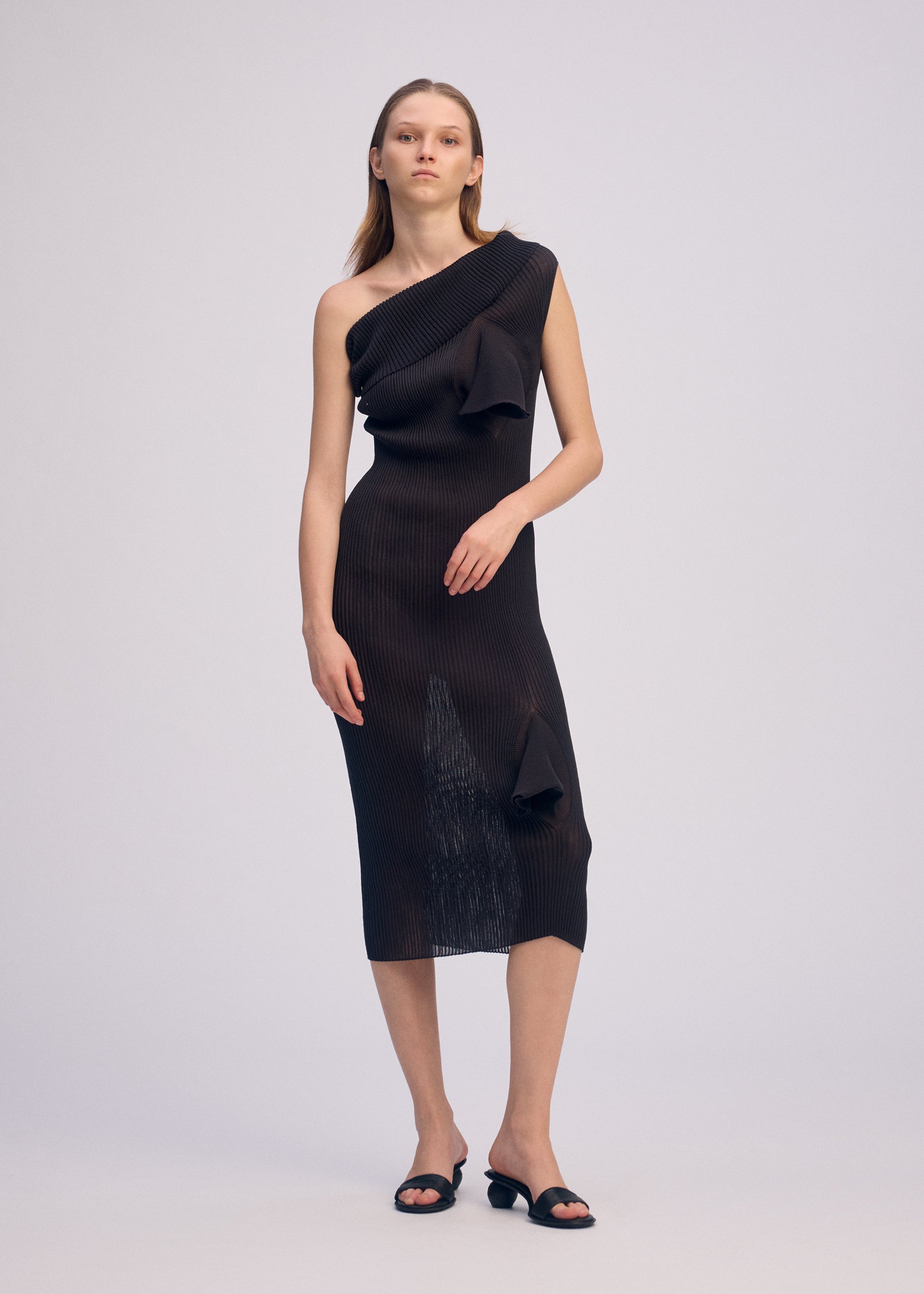 A model wears the ISSEY MIYAKE ADVENTITIOUS HIGH NECKS dress.