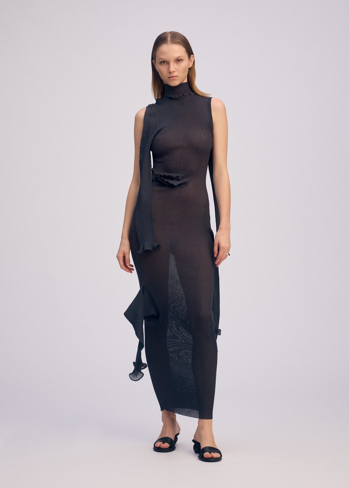 A model wears the ISSEY MIYAKE ADVENTITIOUS SLEEVES dress.