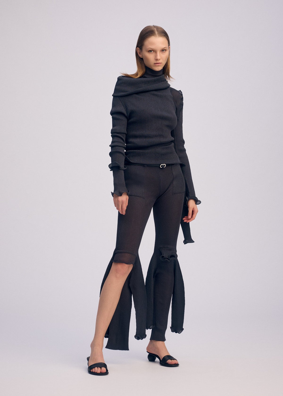 A model wears the ISSEY MIYAKE ADVENTITIOUS SLEEVES dress.