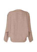 A detail shot of the ISSEY MIYAKE CAMPAGNE top.