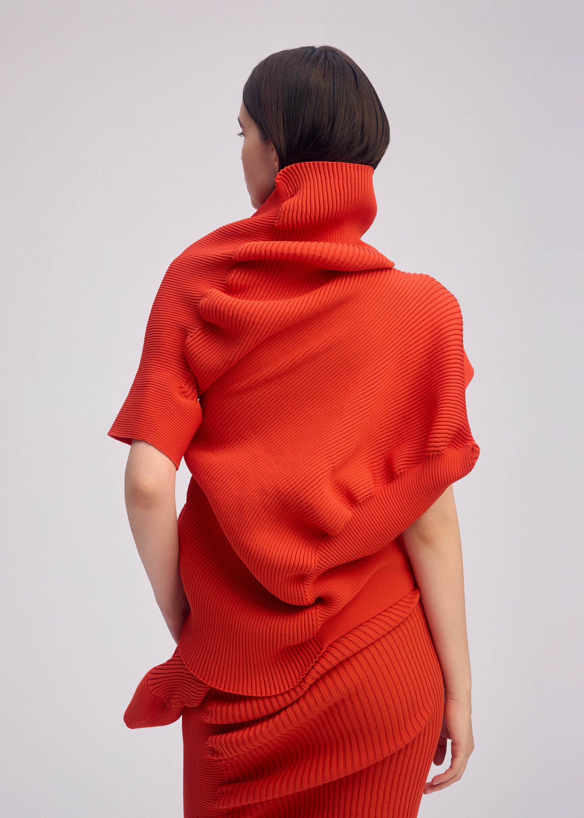 A model wears the ISSEY MIYAKE LIFE FORM top.