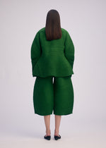 A model wears the ISSEY MIYAKE CORRUGATED KNIT top.