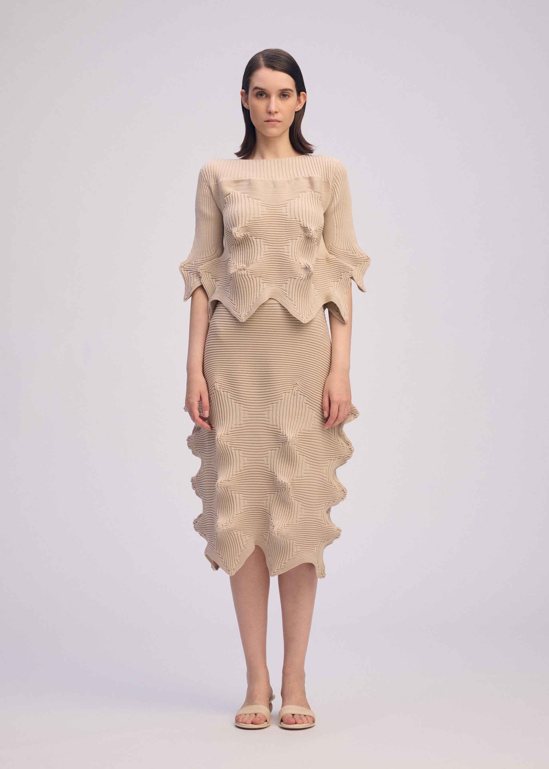 A model wears the ISSEY MIYAKE LINKAGE top.