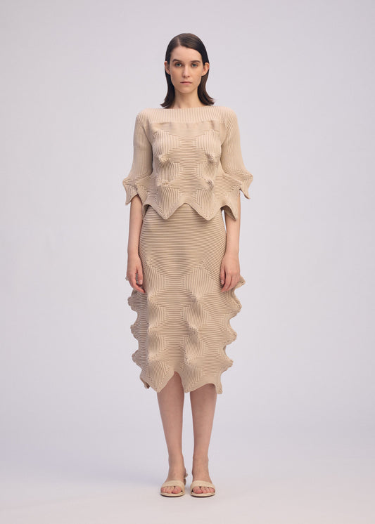 A model wears the ISSEY MIYAKE LINKAGE top.