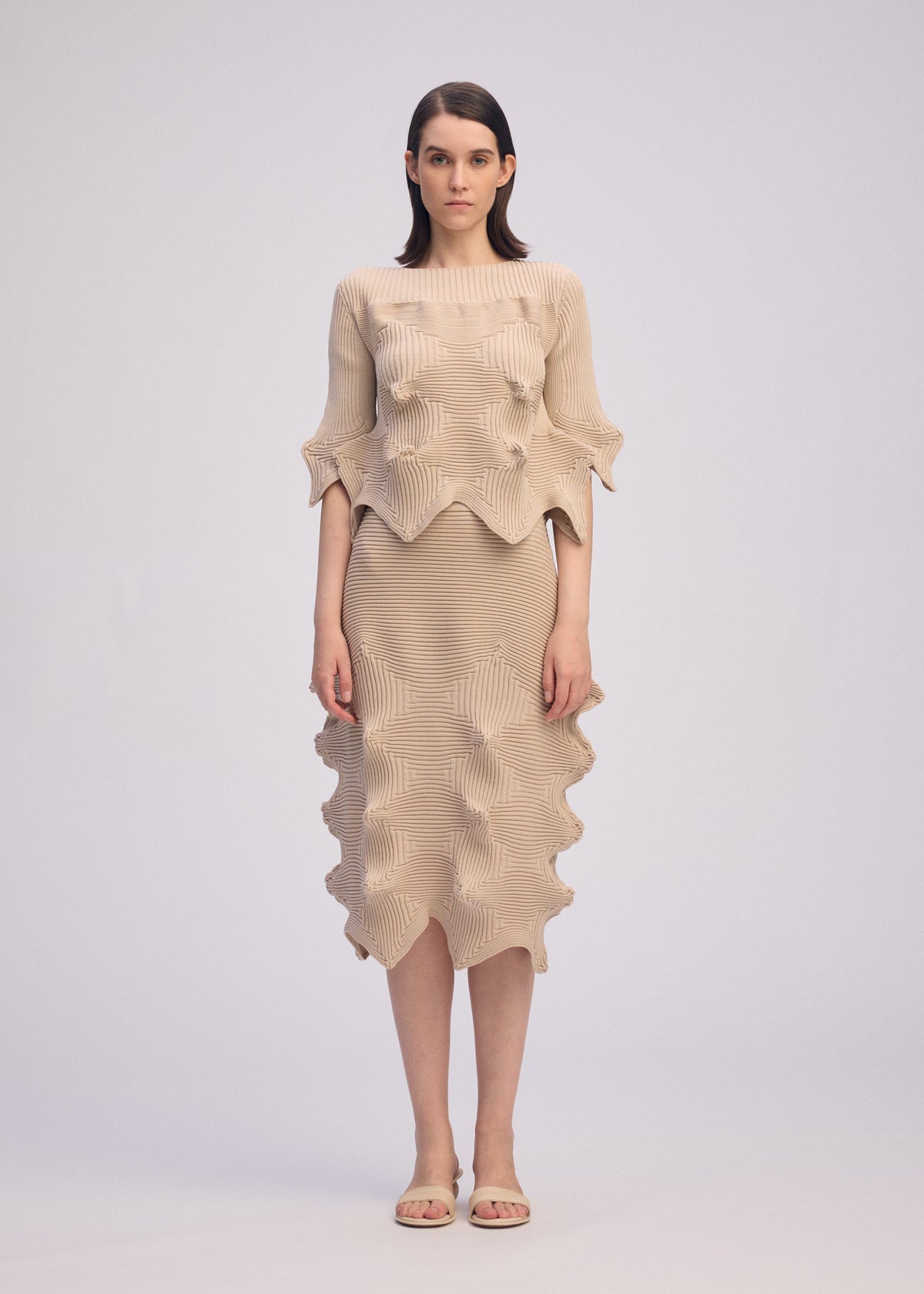 A model wears the ISSEY MIYAKE LINKAGE top.