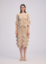 A model wears the ISSEY MIYAKE LINKAGE top.