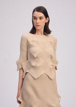 A model wears the ISSEY MIYAKE LINKAGE top.