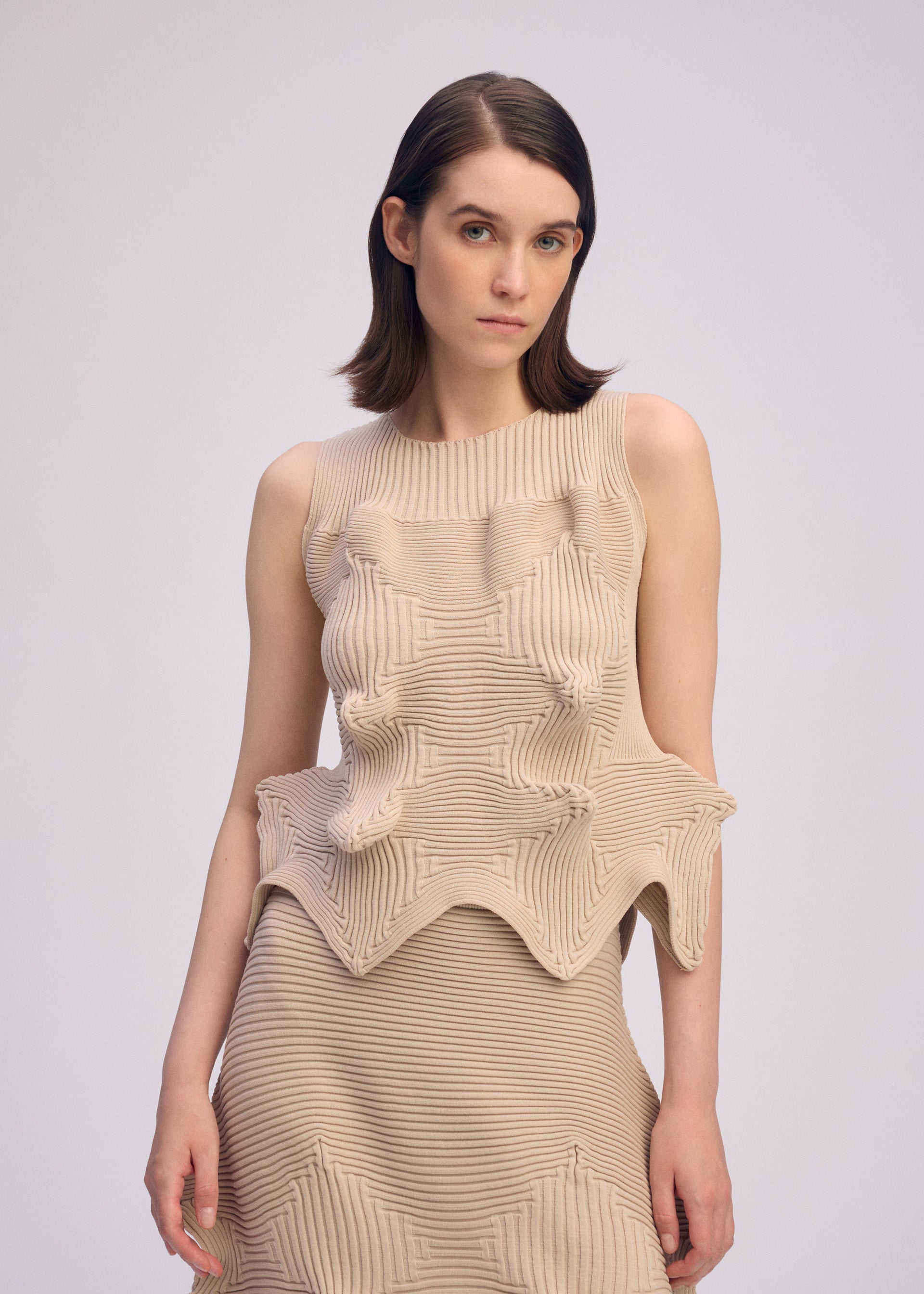 A model wears the ISSEY MIYAKE LINKAGE top.