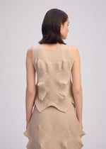 A model wears the ISSEY MIYAKE LINKAGE top.