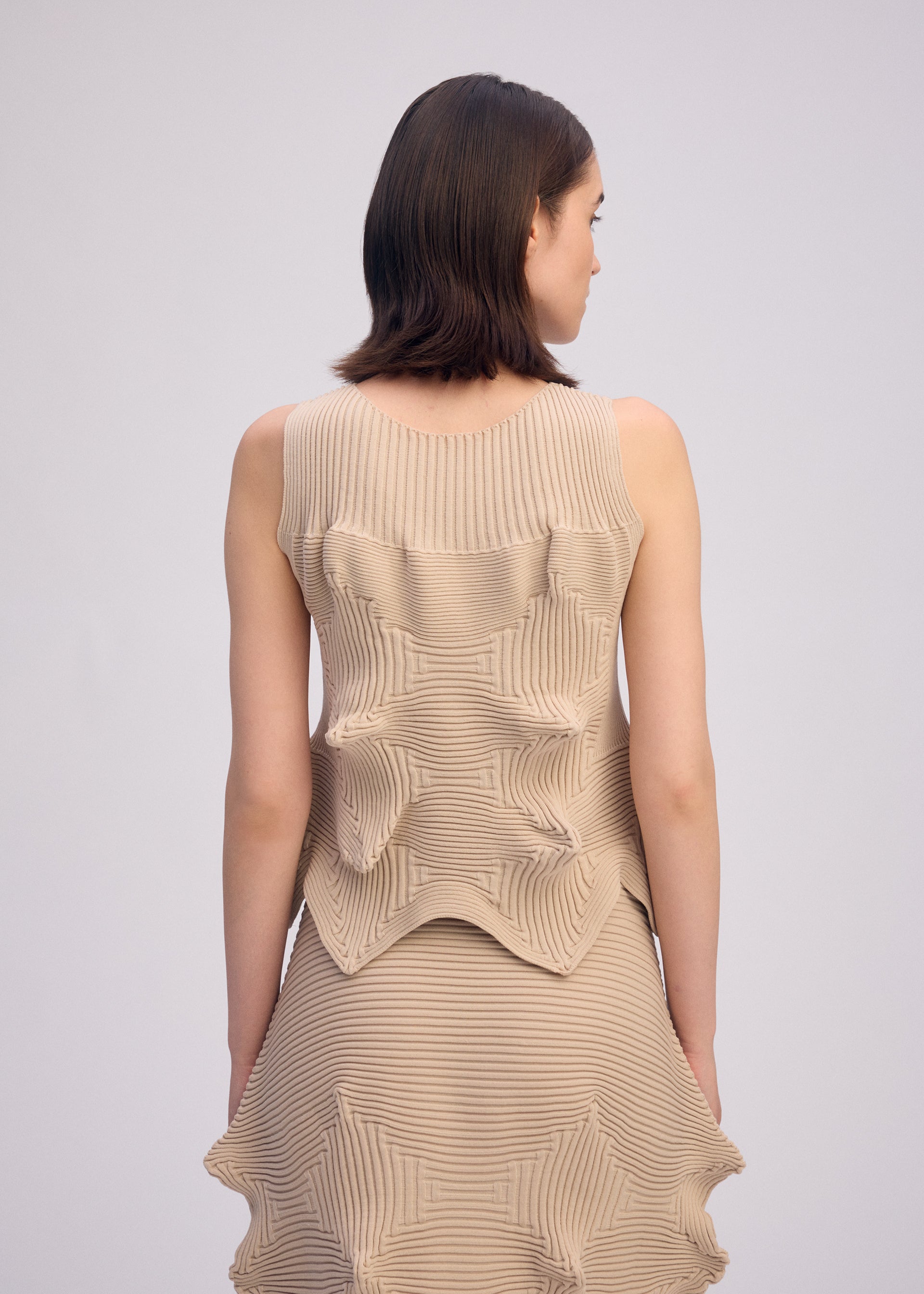 A model wears the ISSEY MIYAKE LINKAGE top.