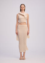 A model wears the ISSEY MIYAKE ADVENTITIOUS HIGH NECKS top.