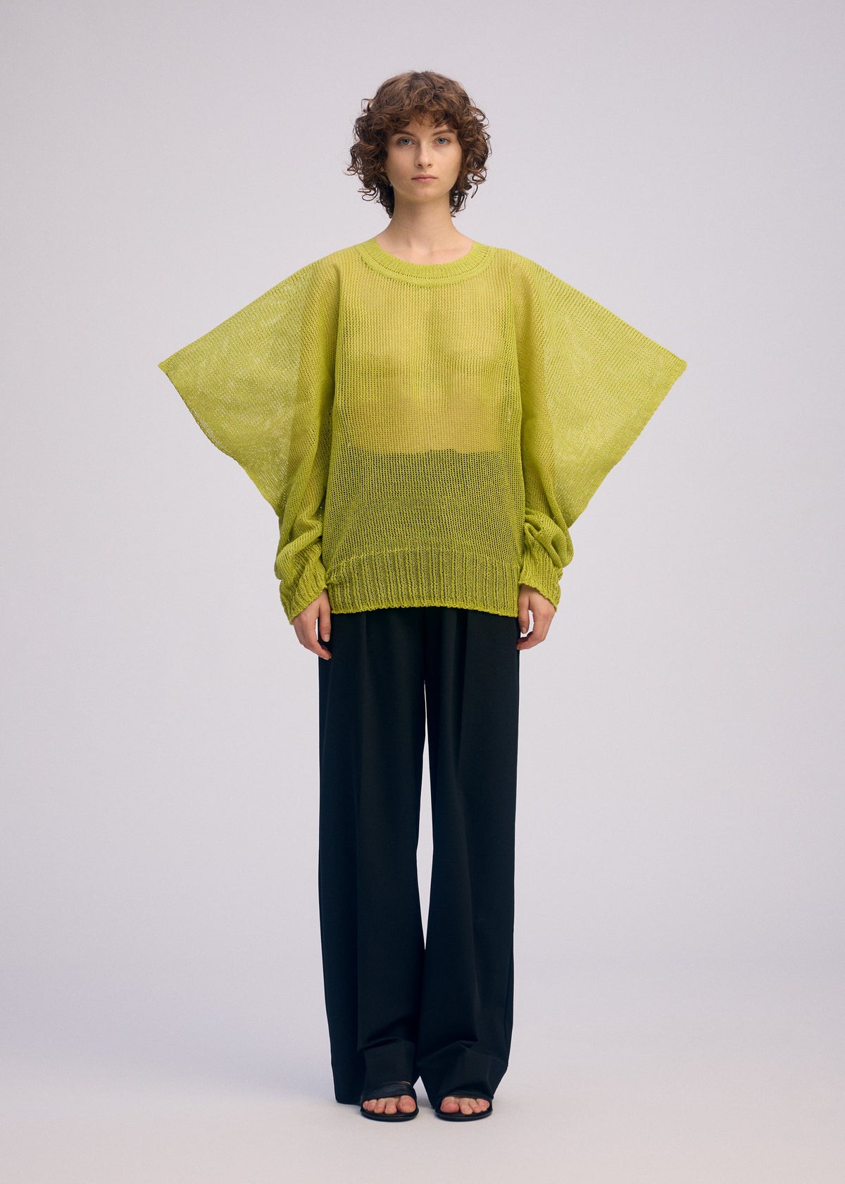 A model wears the ISSEY MIYAKE CIALDA top.