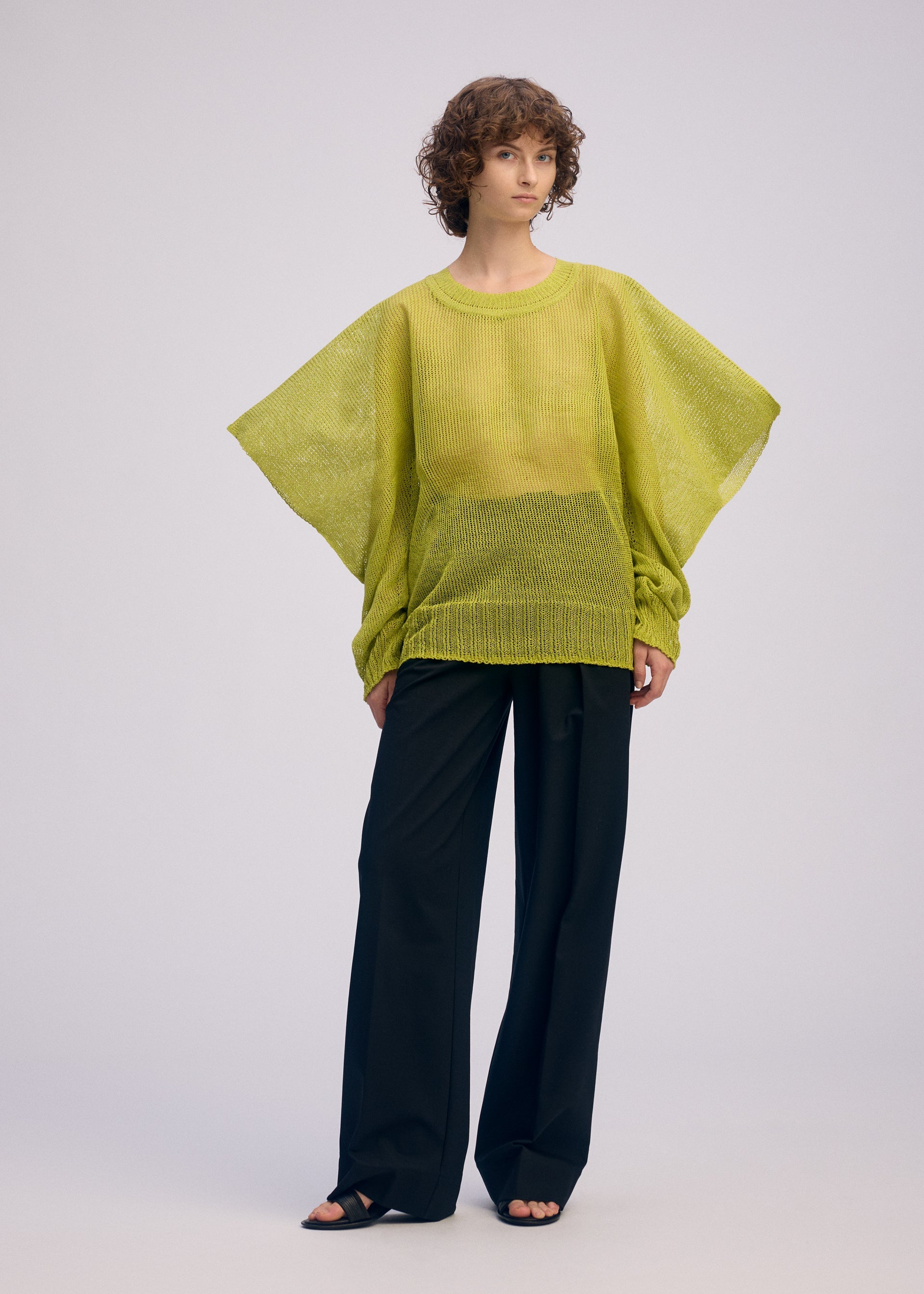 A model wears the ISSEY MIYAKE CIALDA top.