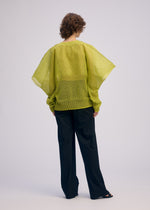 A model wears the ISSEY MIYAKE CIALDA top.