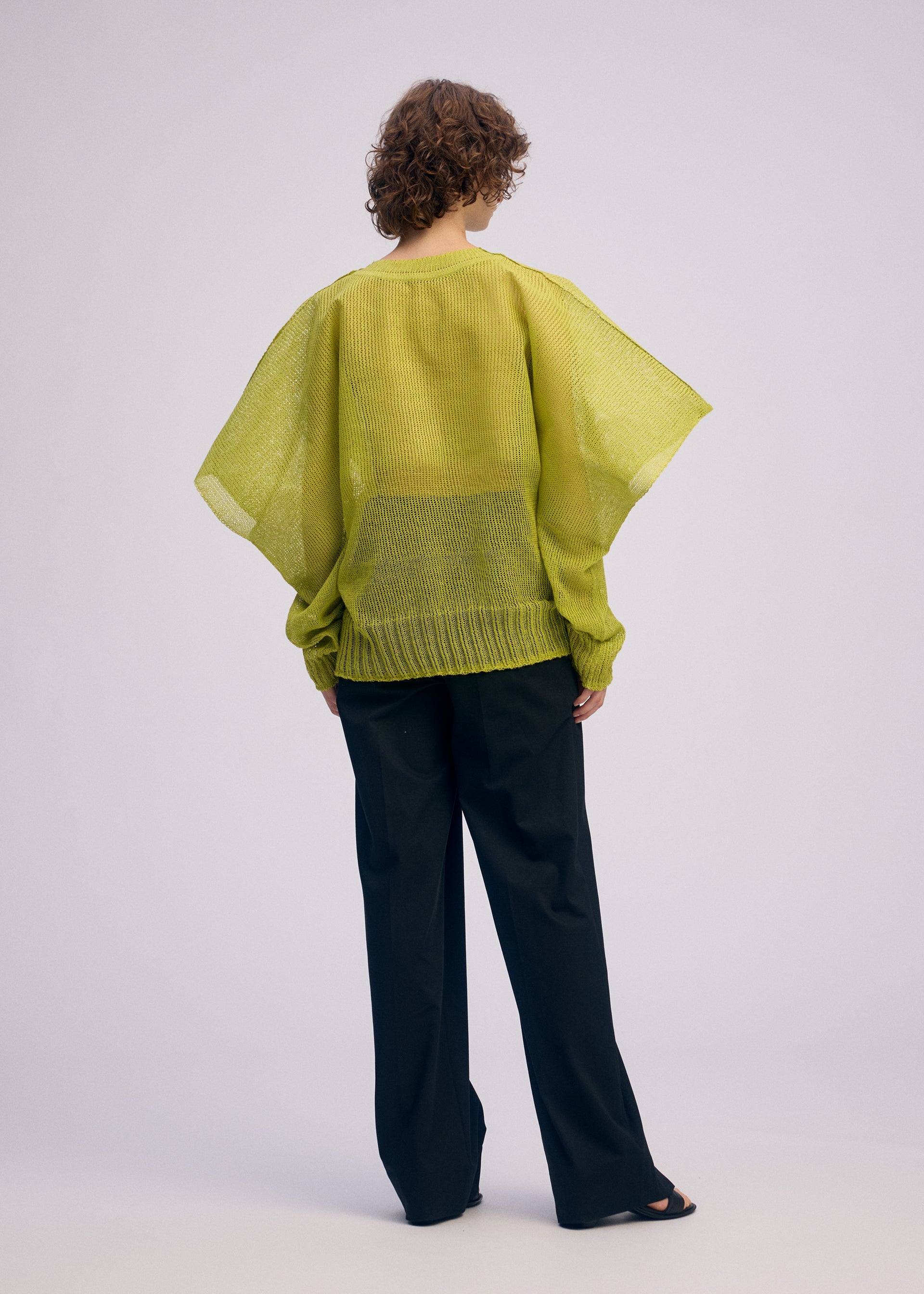 A model wears the ISSEY MIYAKE CIALDA top.