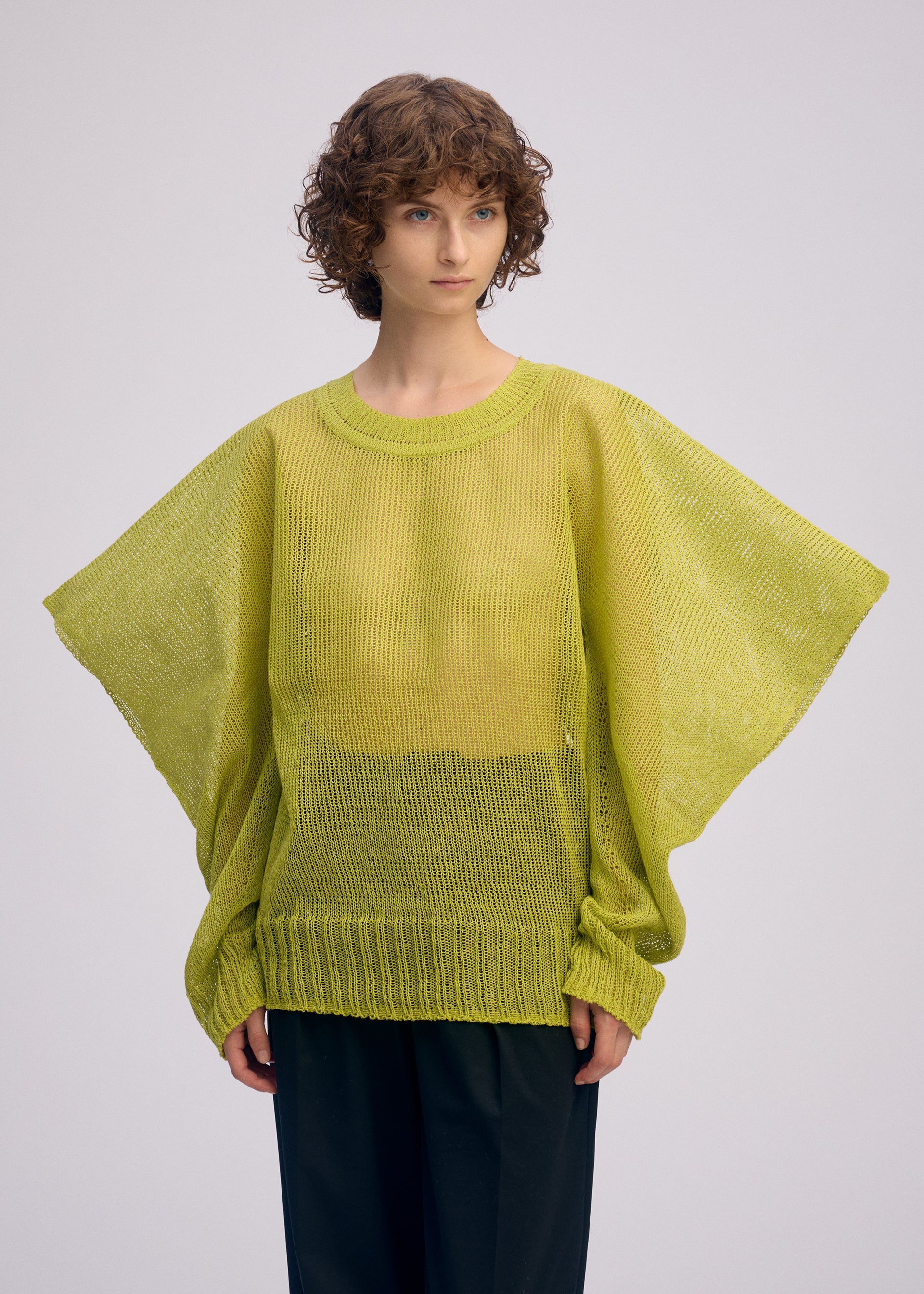 A model wears the ISSEY MIYAKE CIALDA top.