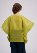 A model wears the ISSEY MIYAKE CIALDA top.