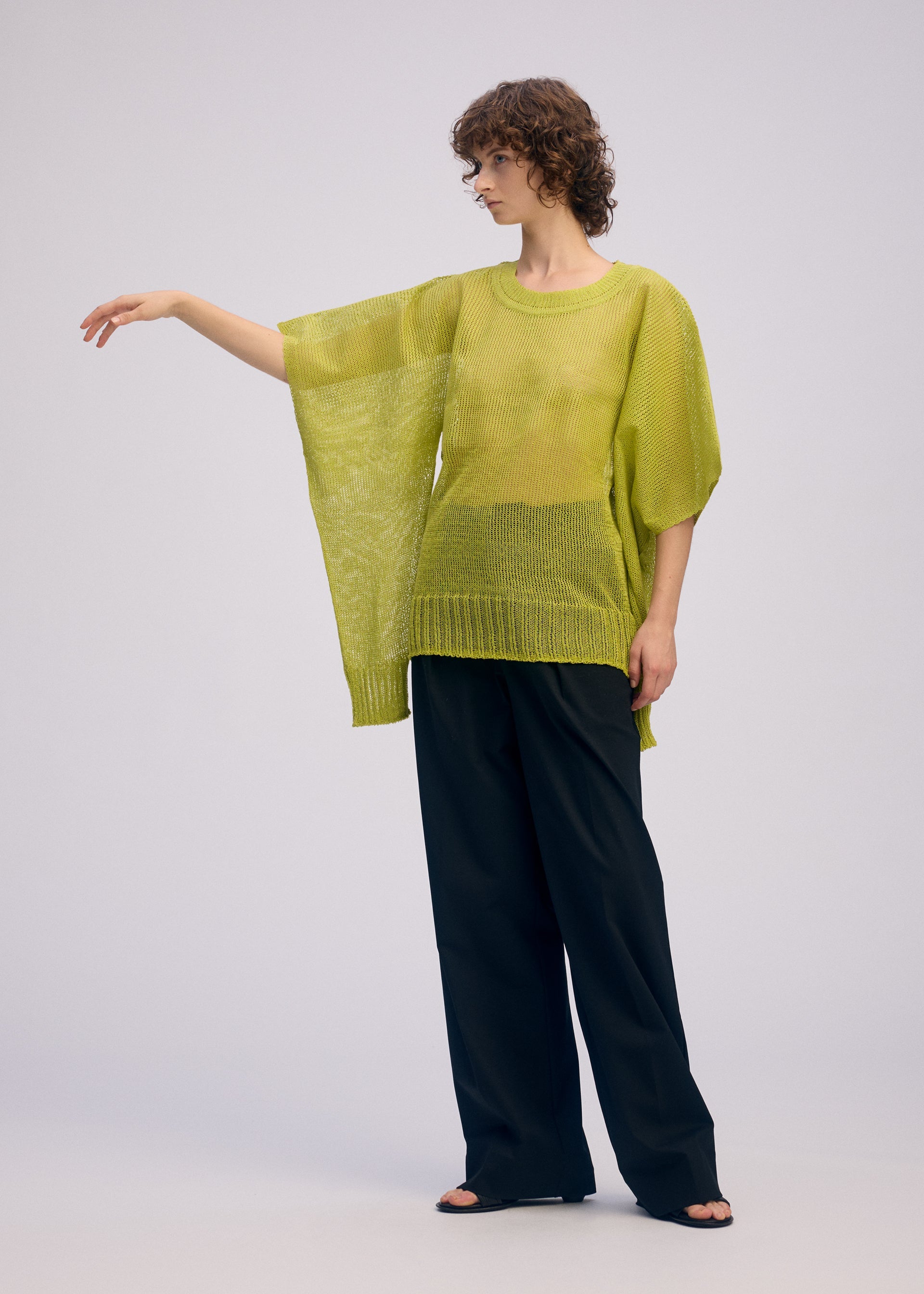 A model wears the ISSEY MIYAKE CIALDA top.