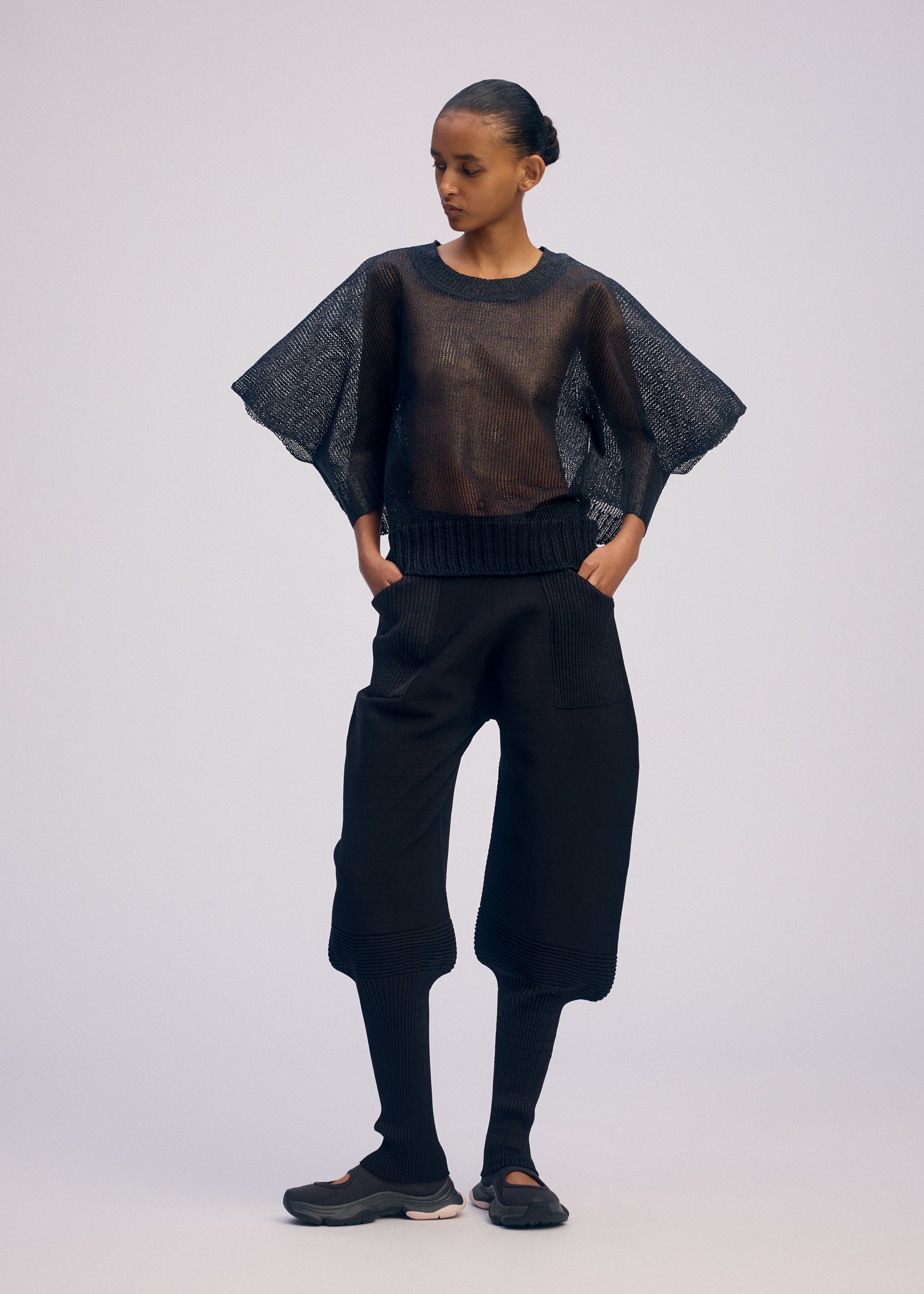 A model wears the ISSEY MIYAKE CIALDA top.