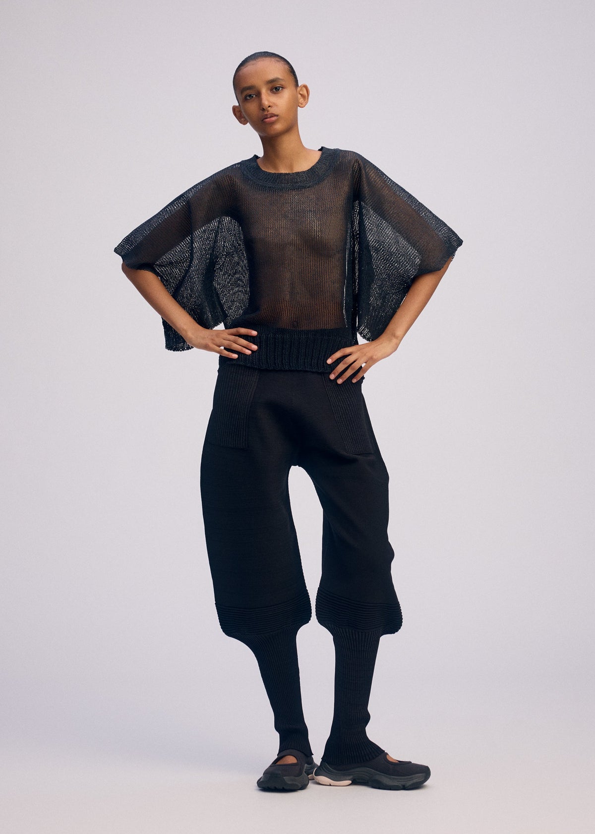 A model wears the ISSEY MIYAKE CIALDA top.