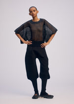 A model wears the ISSEY MIYAKE CIALDA top.